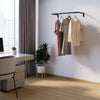 Wall mounted clothes rail made from square iron pipes in black powder coating for jackets in the office