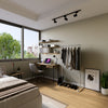 studio apartment design with minimalistic free standing clothes rack in silver water pipes